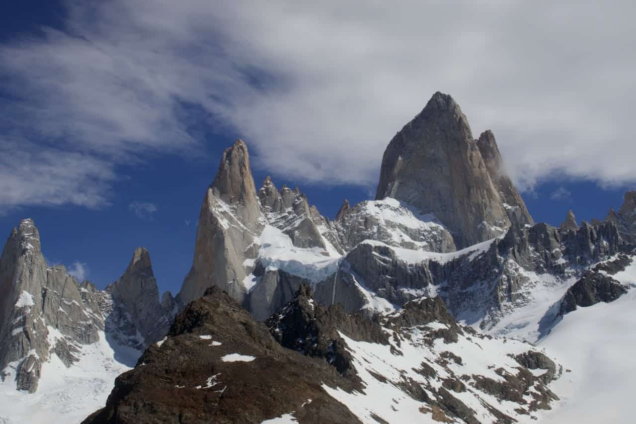 services-09 Snow-capped peaks of Fitz Roy in Patagonia under a bright blue sky.