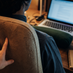 Point dans le milieu du dos : main sur le haut du dos au bureau